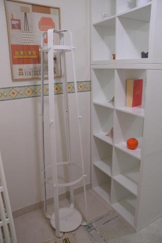 a white closet with a glass shelf and a toilet at Luciano And Son in Campobasso