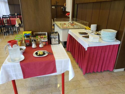 a table with plates of food on top at Pansion Ruža in Novi Vinodolski