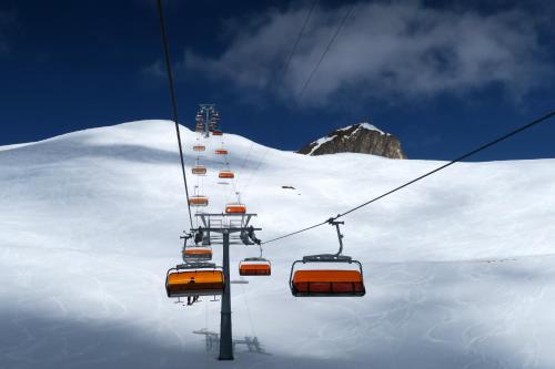 a ski lift going up a snow covered mountain at Engadin Lodge PREMIUM & PRIVATE in Samnaun