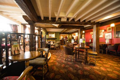 a restaurant with tables and chairs in a room at The Twelve Knights in Port Talbot