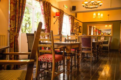a restaurant with a table and chairs and a window at The Twelve Knights in Port Talbot