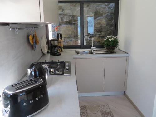 a kitchen with a coffee maker on a counter at Ficano's Dream in San Siro