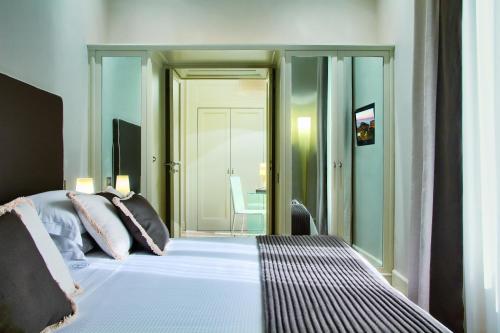 a bedroom with a bed and a sliding glass door at Grand Hotel Excelsior Vittoria in Sorrento