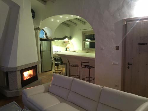 a living room with a couch and a fireplace at Stazzo Serafini in Rena Majore