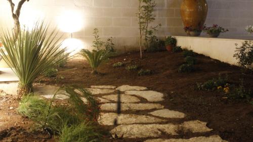 a garden with plants and a stone path at La Buona Creanza by Jdvacanze in Manduria