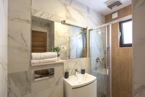 a bathroom with a sink and a shower at Lux Apartments Petar in Baška Voda