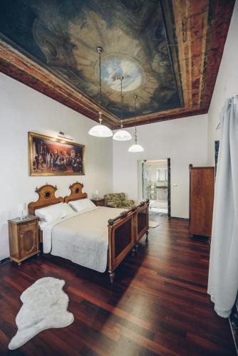 a bedroom with a bed with a painting on the ceiling at Feel Ljubljana Centre in Ljubljana