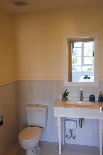 a bathroom with a toilet and a sink and a window at 2 Bedroom Summer Huahin Condominium in Hua Hin