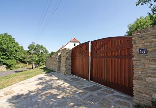 a wooden fence next to a stone wall at U Slunce in Čížov