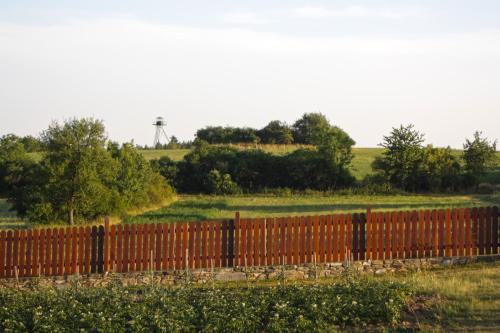 a fence in a field with a water tower in the background at U Slunce in Čížov