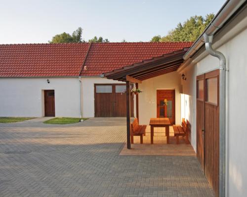 a patio with a table and chairs next to a building at U Slunce in Čížov