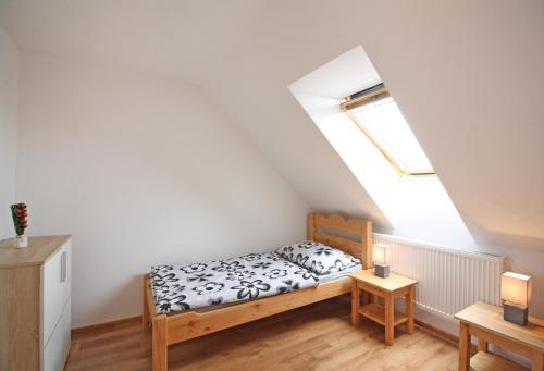 a small bedroom with a bed in a attic at U Slunce in Čížov