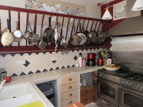 a kitchen with pots and pans hanging on the wall at 18 châteaux et Beauval sur un rayon de 30 km in Saint-Georges-sur-Cher