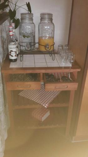 a wooden shelf with jars and glasses on it at Hotel Trendtino in Eisenberg