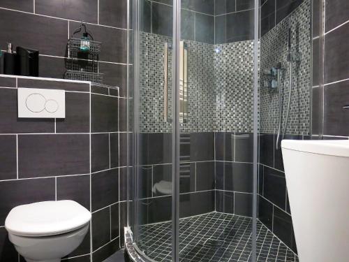 a bathroom with a shower and a toilet at Loft Marais Sébastopol CityCosy in Paris