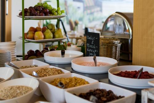 a table topped with bowls of food on a counter at Hotel Wald und See in Heringsdorf