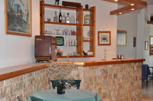 a bar in a restaurant with a brick wall at Lydia Rooms & Studios in Preveza