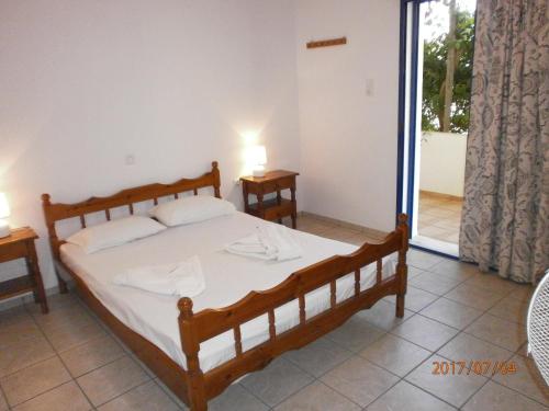 1 dormitorio con 1 cama y puerta corredera de cristal en Fragokastello Star, en Frangokastello