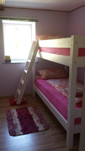 a bedroom with two bunk beds and a window at Ferienhaus Peggy in Kurort Oybin