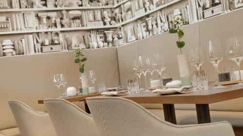 a dining room with a table with chairs and glasses at Hotel Stadt Lörrach in Lörrach