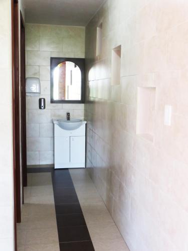 a bathroom with a white sink and a mirror at Casa del Montañero in Machachi