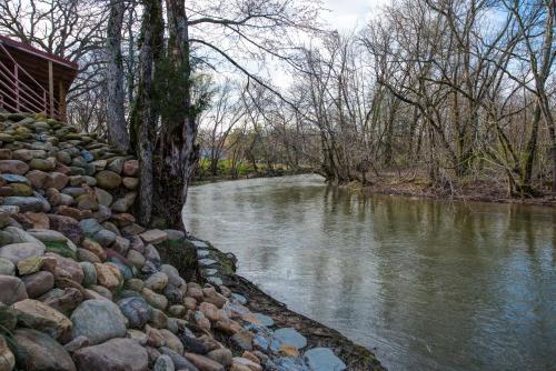 a river with a rock wall next to a river at River Bend Inn - Pigeon Forge in Pigeon Forge