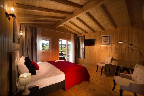 a bedroom with a bed and a desk and a chair at Monte do Zeca in Zambujeira do Mar