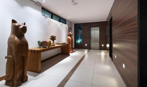 a hallway with a wooden cat statue in a house at Best Western Premier Maceió in Maceió