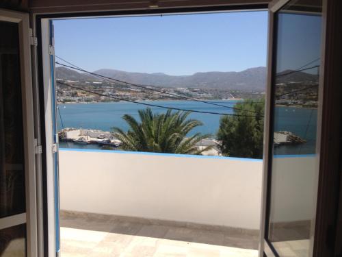 a view from the door of a balcony with a view of the water at Creta Sun Apartments in Makry Gialos
