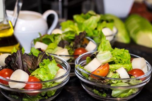 three bowls filled with vegetables on a table at Casa Andina Premium Golf Los Incas in Lima