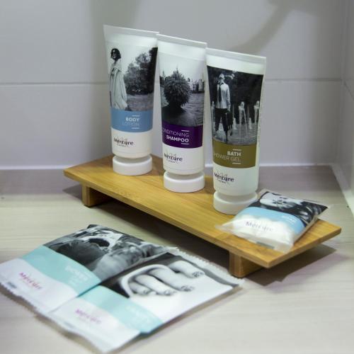 a shelf with three bottles of hair products on it at Mercure Blankenberge in Blankenberge