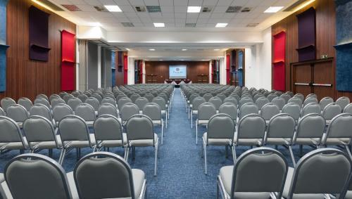 an empty conference room with chairs and a screen at Best Western Premier Maceió in Maceió