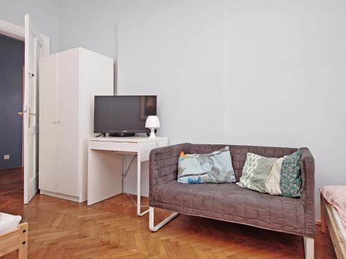 a living room with a couch and a tv at 3citygo - Hostel Gdynia 2017 in Gdynia