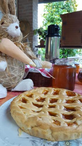 a pie sitting on top of a table next to a stuffed animal at Podere Chiasso Gherardo in Peccioli