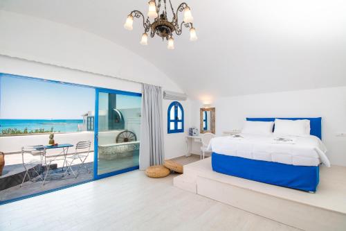 a bedroom with a bed and a view of the ocean at Dimitra Boutique Rooms in Faliraki