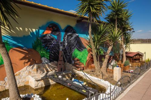 a mural of birds on the side of a building at Villa Gengi in Ardea