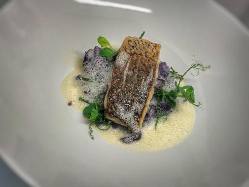 a white plate with a piece of food on it at Pen-Y-Dyffryn Country Hotel in Oswestry