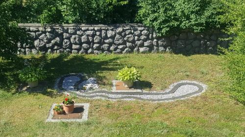 a garden with a fake snake in the grass at Apartments Barbara in Podhum