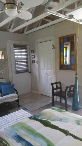 a room with a bed and a chair and a door at Domaine de la Baie, Les Suites in Shawinigan
