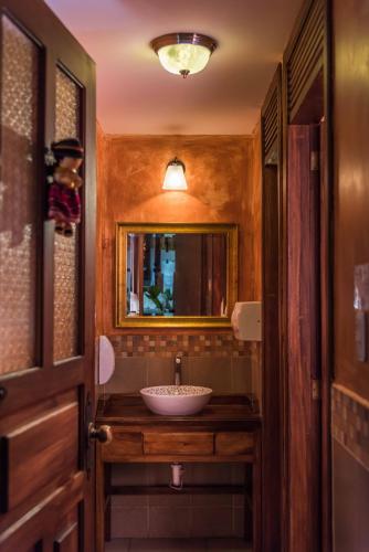 a bathroom with a sink and a mirror at Hotel San Francisco De Quito in Quito