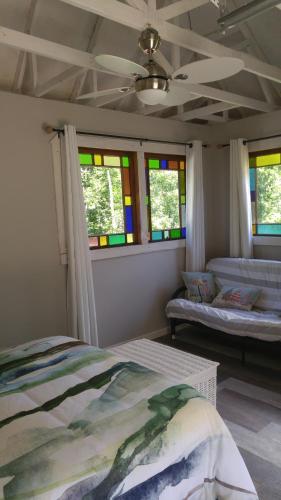a bedroom with a bed and stained glass windows at Domaine de la Baie, Les Suites in Shawinigan