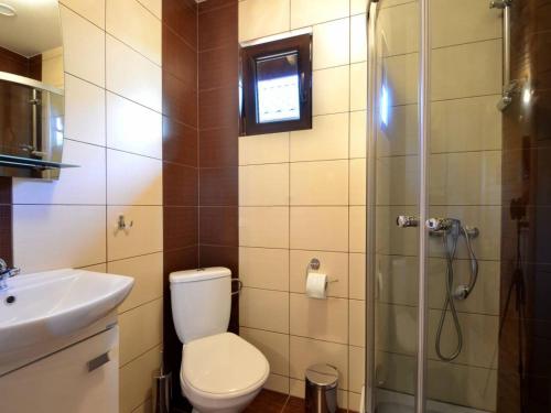 a bathroom with a shower and a toilet and a sink at Morskie Zacisze in Gąski