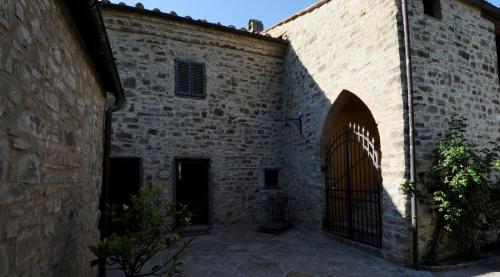 a brick building with a gate in front of it at La Rimbecca Greve in Chianti in Greve in Chianti