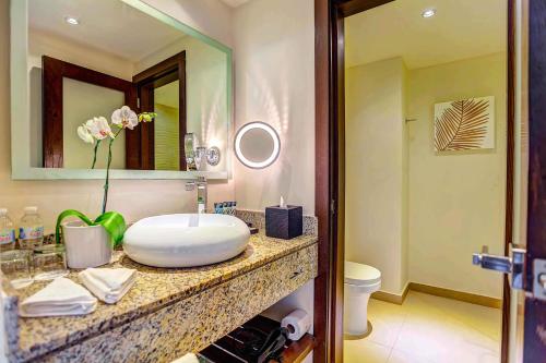 a bathroom with a sink and a mirror at Hideaway at Royalton Punta Cana, An Autograph Collection All-Inclusive Resort & Casino, Adults Only in Punta Cana