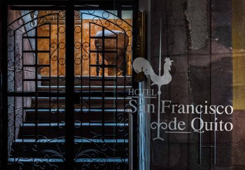 a door with a peacock sticker on the glass at Hotel San Francisco De Quito in Quito