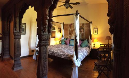 a bedroom with a canopy bed in a room at Old England House in Minas de Ríotinto