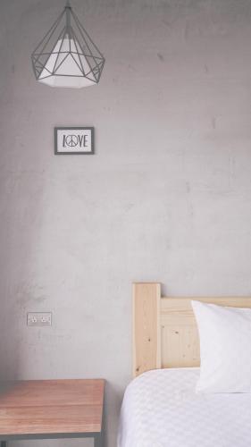 a bedroom with a bed and a sign on the wall at The Red Hotel in Nanwan