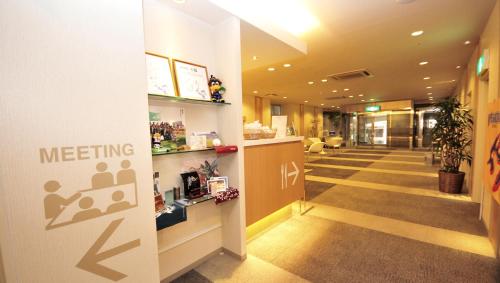 a lobby of a hospital with a meeting sign on the wall at Hotel Premium Green Plus in Sendai