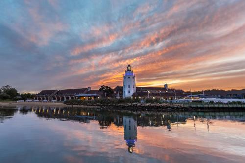 a lighthouse in the middle of a body of water at Montauk Yacht Club in Montauk