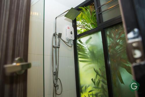 a shower in a bathroom next to a window at Green@Buriram in Buriram